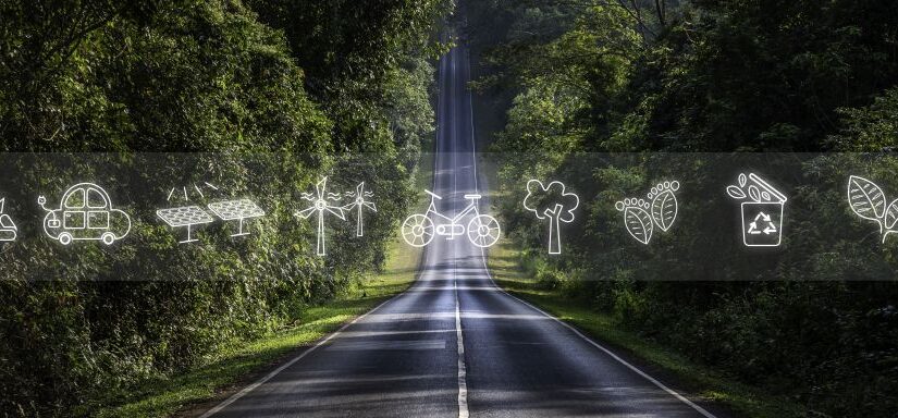 Grafika z drogą i symbolicznymi znakami, takimi jak rower, panele fotowoltaiczne, samochód elektryczny, drzewo